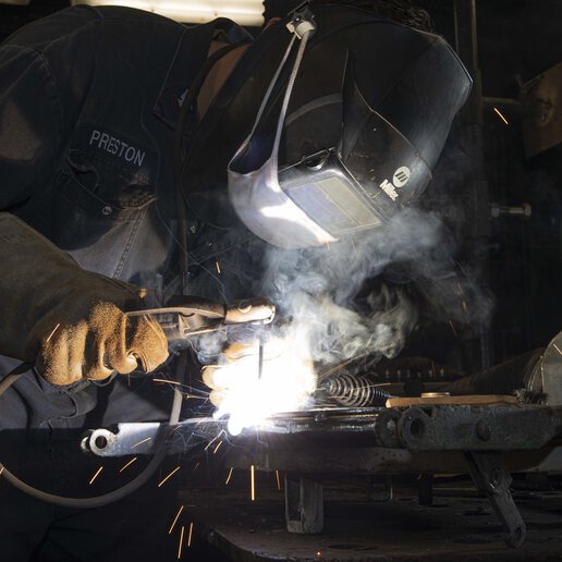 Welder welding in full gear.