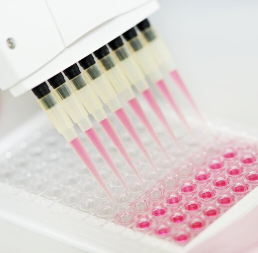 samples being automatically aliquoted into tubes in a lab