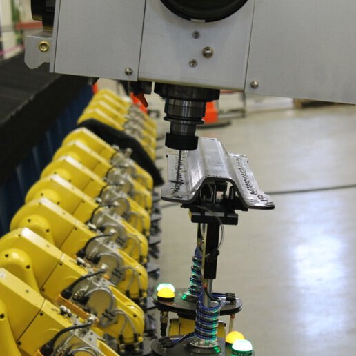 Robotic fixture holding carbon fiber part for drilling