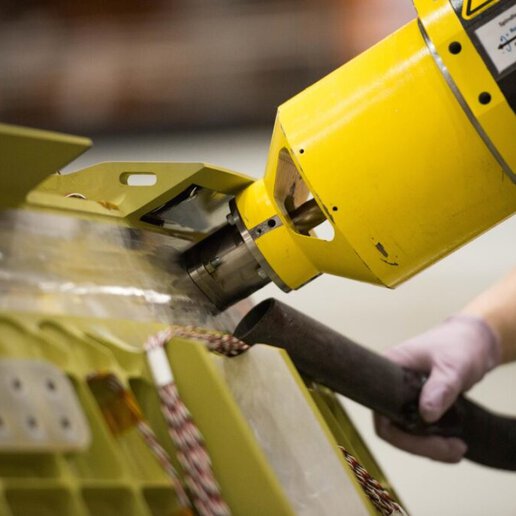 Robot performing friction plug welding operation to fill hole in aluminum alloy