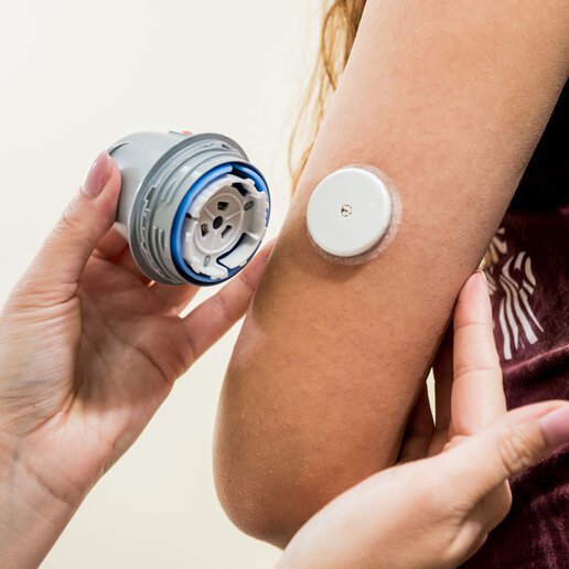 CGM Device being applied to a patient