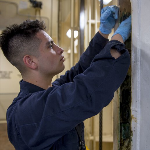 Technician working on a marine personnel elevator.