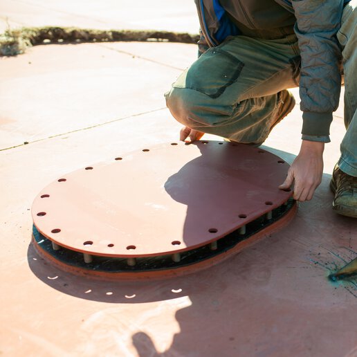 Sailor closing hatch on ship.