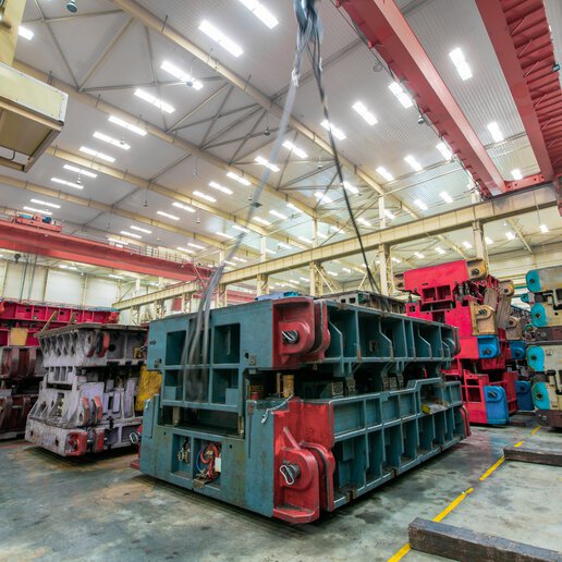 Mold equipment for a car factory in a storage warehouse being lifted by a crane