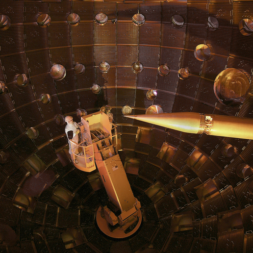 A worker performing service on a manlift in a nuclear environment at NIF Target Chamber