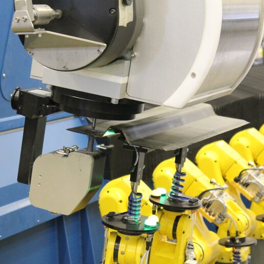 Robotic fixture holding carbon fiber part for drilling