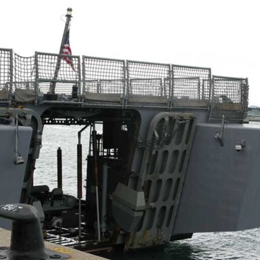 Custom side-port module with shell door on a ship.