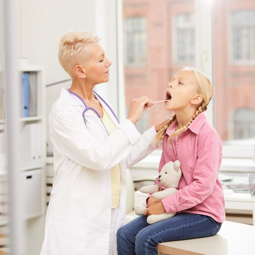 doctor examining young patient in doctors office