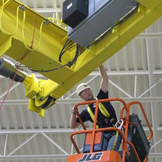 Crane operator servicing crane on a TensileTruss Platform.